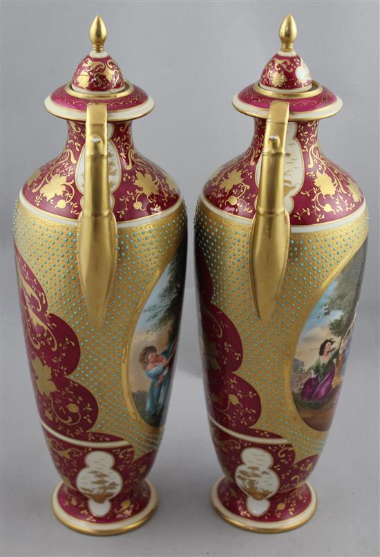 A pair of Vienna style porcelain twin handled vases and covers, c.1880-1900, 41.5cm, damages to cove